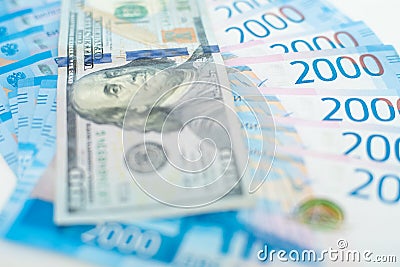 American 100 dollar banknote and 2000 russian roubles. Concept trade, cooperation or wrestling. Stock Photo