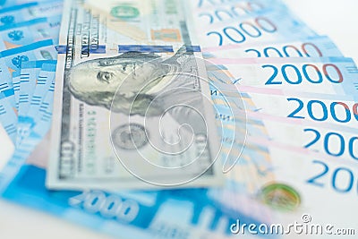 American 100 dollar banknote and 2000 russian roubles. Concept trade, cooperation or wrestling. Stock Photo