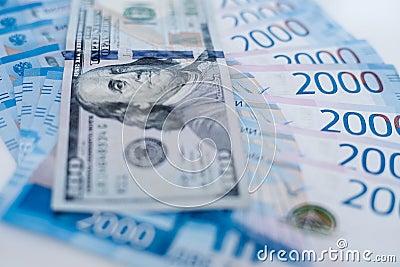 American 100 dollar banknote and 2000 russian roubles. Concept trade, cooperation or wrestling. Stock Photo