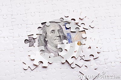 American dollar hidden under puzzle pieces Stock Photo