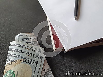 American dollar money, books and pen Stock Photo