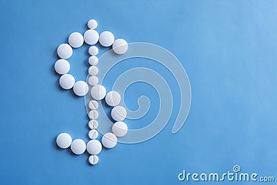 American dollar sigh made of white round pills. Pharmacy background. Wealth concept. Stock Photo