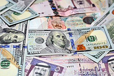 American 100 dollars banknotes and Saudi Arabia riyals currency banknotes, Saudi Arabia money and American dollars currencies Stock Photo