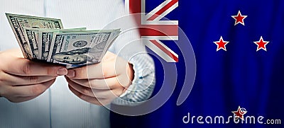 American dollars cash money on New Zealand flag background Stock Photo