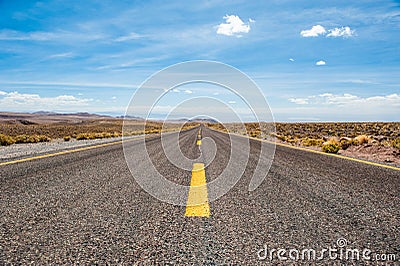 American empty desert asphalt road from low angle with mountains and clouds on background. South american highway in Atacama deser Stock Photo