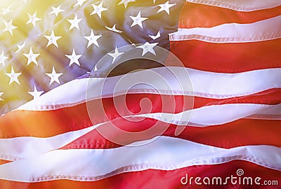 American flag background. Brightly lit American flag. Sunlight, sunflare on the right side. Stock Photo