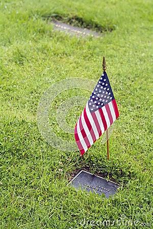 American flag and Flowers on veteran Graveside Stock Photo