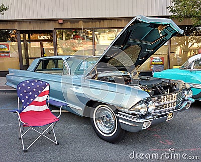 American Flag Lawn Chair Near a Classic Car at a Car Show Editorial Stock Photo