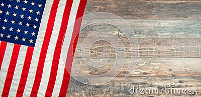 American flag lying on an aged, weathered rustic wooden background Stock Photo