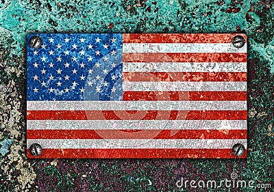 American flag on metal plate screwed screws on wall Stock Photo