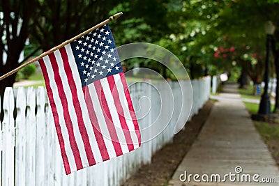 American flag on a picket fence. Stock Photo
