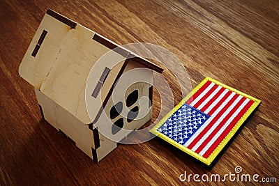 American flag and small house. VA mortgage loan concept Stock Photo