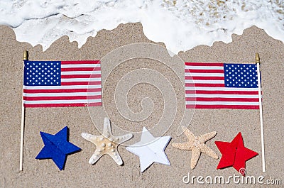 American flag with starfishes on the sandy beach Stock Photo