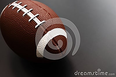 American football on black background. Sport object concept Stock Photo