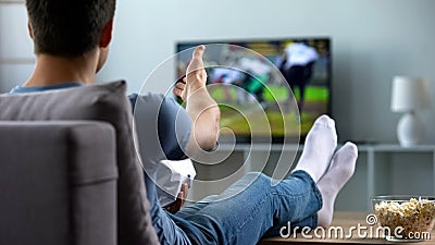 American football fan rejoicing at goal scored by favourite team, championship Stock Photo