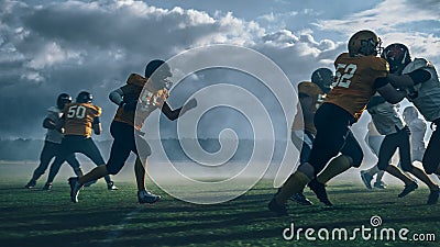 American Football Field Two Teams Play: Successful Player Running Around Defense Players to Score Stock Photo