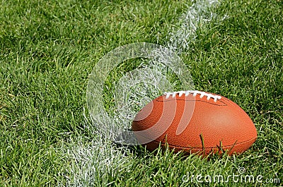 American Football on Natural Grass Field Stock Photo