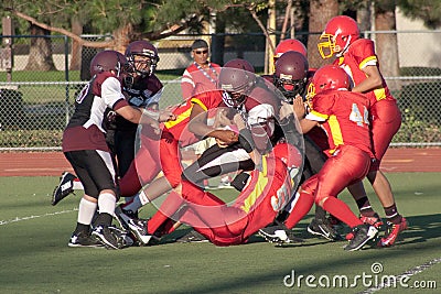 American Football Player Being Tackled During a Ga Editorial Stock Photo