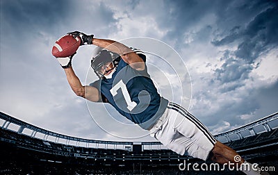 American Football Player Catching a touchdown Pass Stock Photo