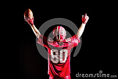 American football player cheering with arms up Stock Photo