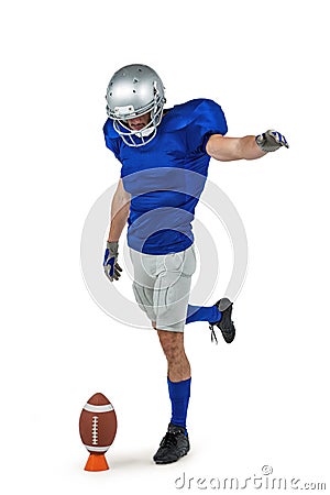 American football player kicking ball Stock Photo