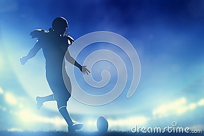 American football player kicking the ball, kickoff Stock Photo