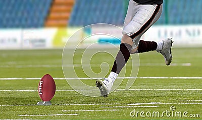 American football player kickoff on field Stock Photo