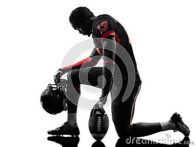 American football player kneeling silhouette Stock Photo