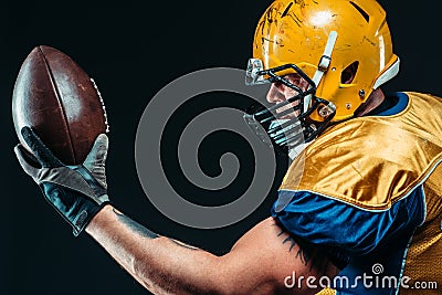 American football player with laced ball in hands Stock Photo