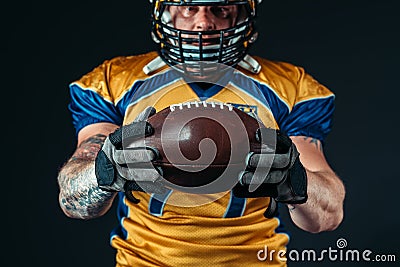 American football player with laced ball in hands Stock Photo