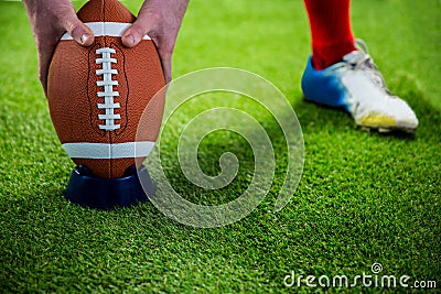 American football player preparing for a drop kick Stock Photo
