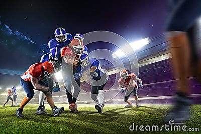 American football players in action on grand arena Stock Photo