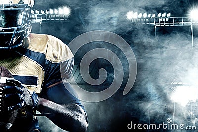 American football sportsman player on stadium with lights on background with copy space Stock Photo