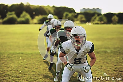 American football team doing drills on a sports field Stock Photo