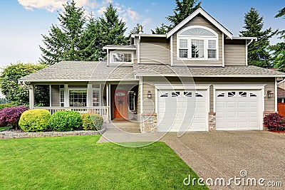 American house exterior with double garage and well kept lawn. Stock Photo