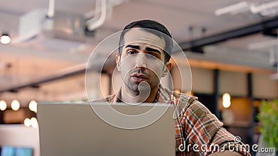 An American male teacher uses a laptop computer to chat with a friend. to be reviewing to prepare to teach students and in the Stock Photo