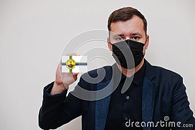 American man wear black formal and protect face mask, hold Little Rock flag card isolated on white background. USA cities Stock Photo