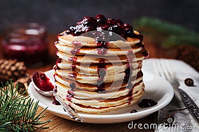 American pancakes or fritters served with strawberry and blueberry jam, delicious dessert for breakfast in winter Stock Photo