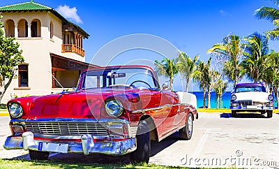 American red and blue white vintage car parked on the beach in Varadero Cuba - Serie Cuba Reportage Editorial Stock Photo