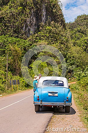 American retro car on the road, Vinales, Pinar del Rio, Cuba. Copy space for text. Vertical. Editorial Stock Photo