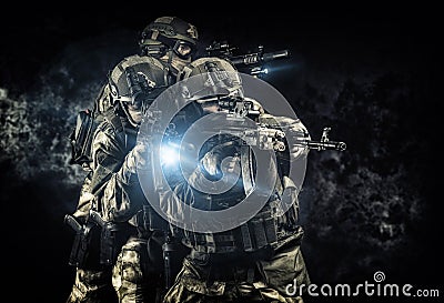 American soldiers in combat ammunition with weapons in the hands of equipped laser sights are in battle order Stock Photo