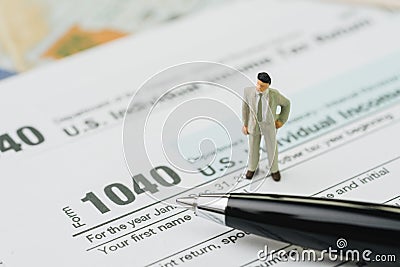 American tax calculation concept, miniature businessman standing Editorial Stock Photo