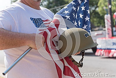 Veteran with US flag and WWI helmet on parade Stock Photo