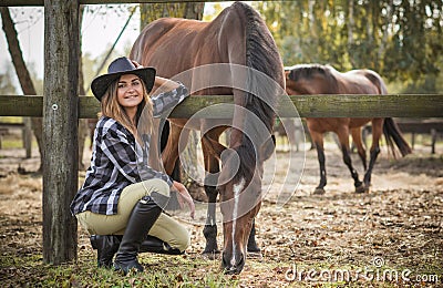American woman on a rancho with a horse, hippotherapy Stock Photo