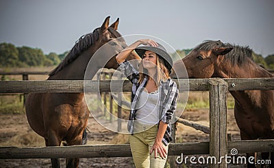 American woman on a rancho with a horse, hippotherapy Stock Photo