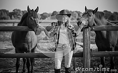 American woman on a rancho with a horse, hippotherapy Stock Photo