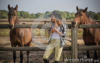 American woman on a rancho with a horse, hippotherapy Stock Photo