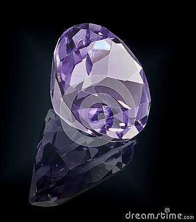 Amethist gem stone on black background Stock Photo