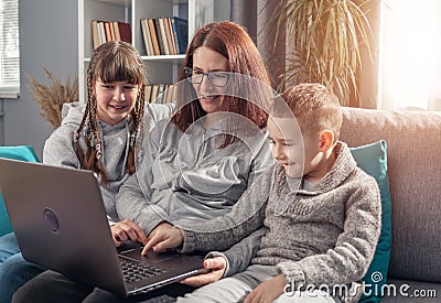 Amicable family using laptop together Stock Photo