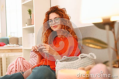 Amicable girl with ginger hair sitting near big window Stock Photo